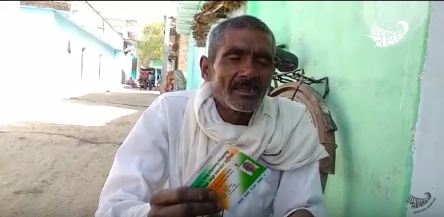 A man holding his aadhaar card