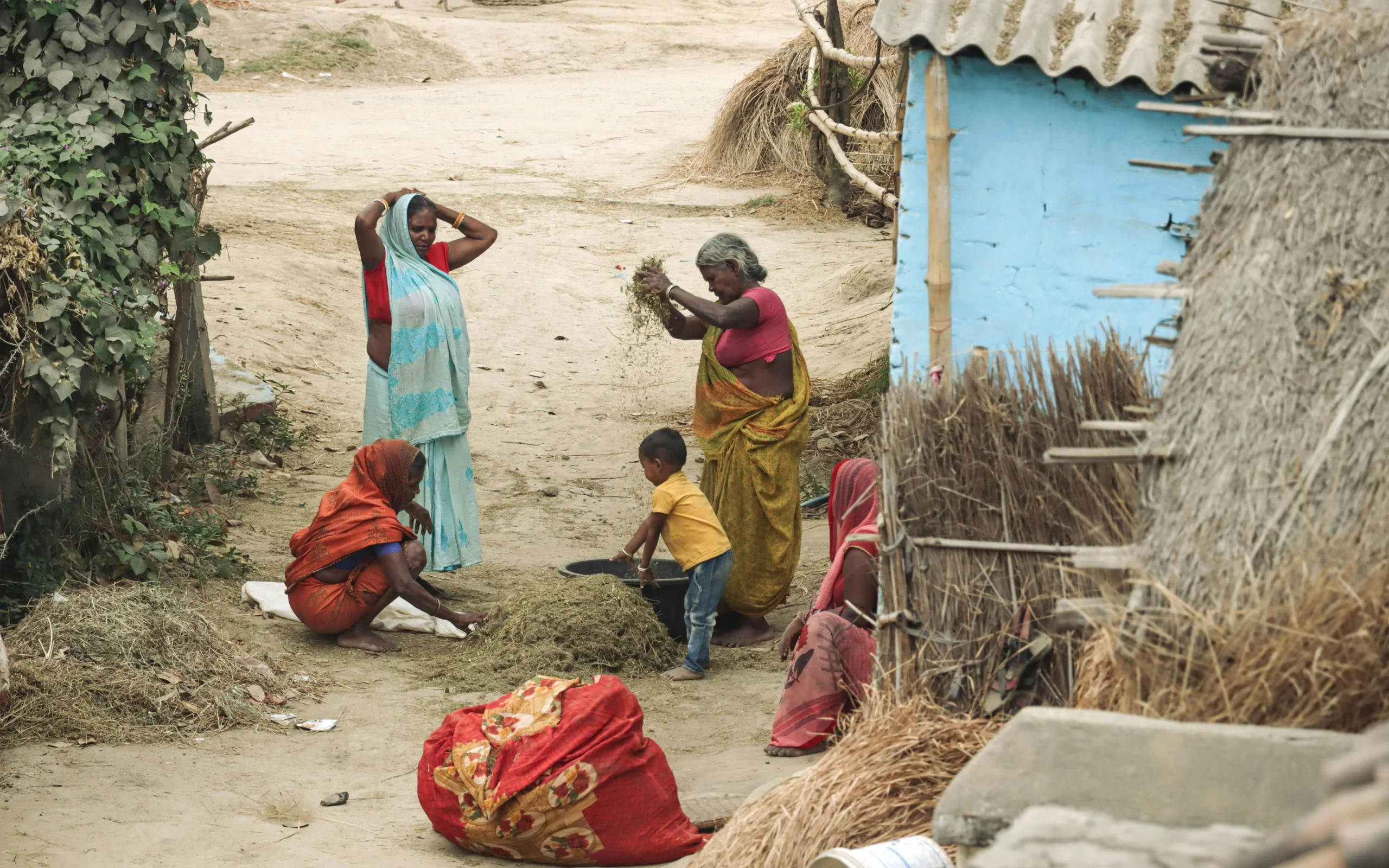 a group of women in Rajasthan talking while doing their chores