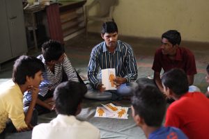 ECF boys sitting around in a circle - prevention of violence against women