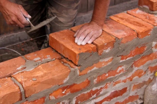Leadership Building Laying Bricks