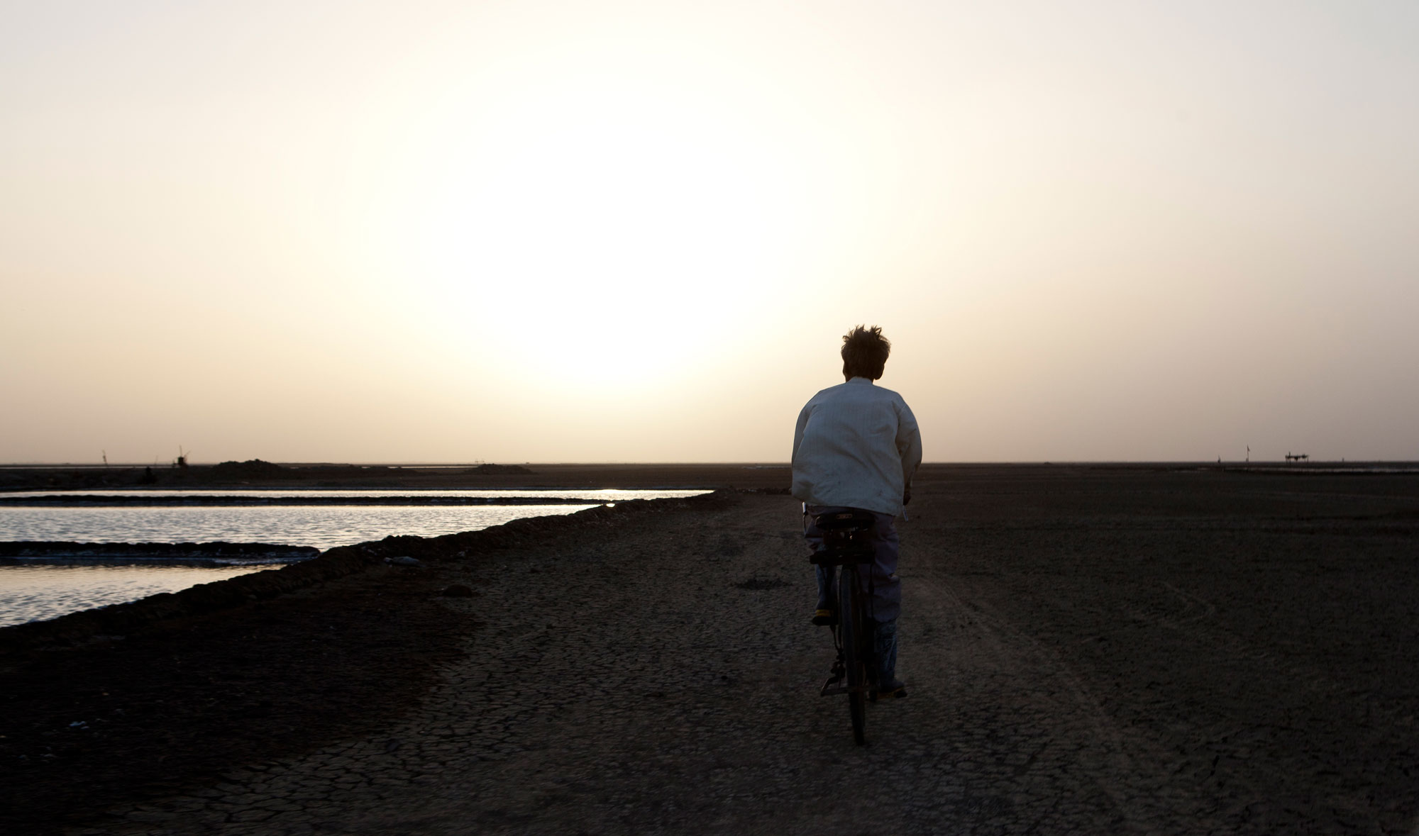 man cycling on open road