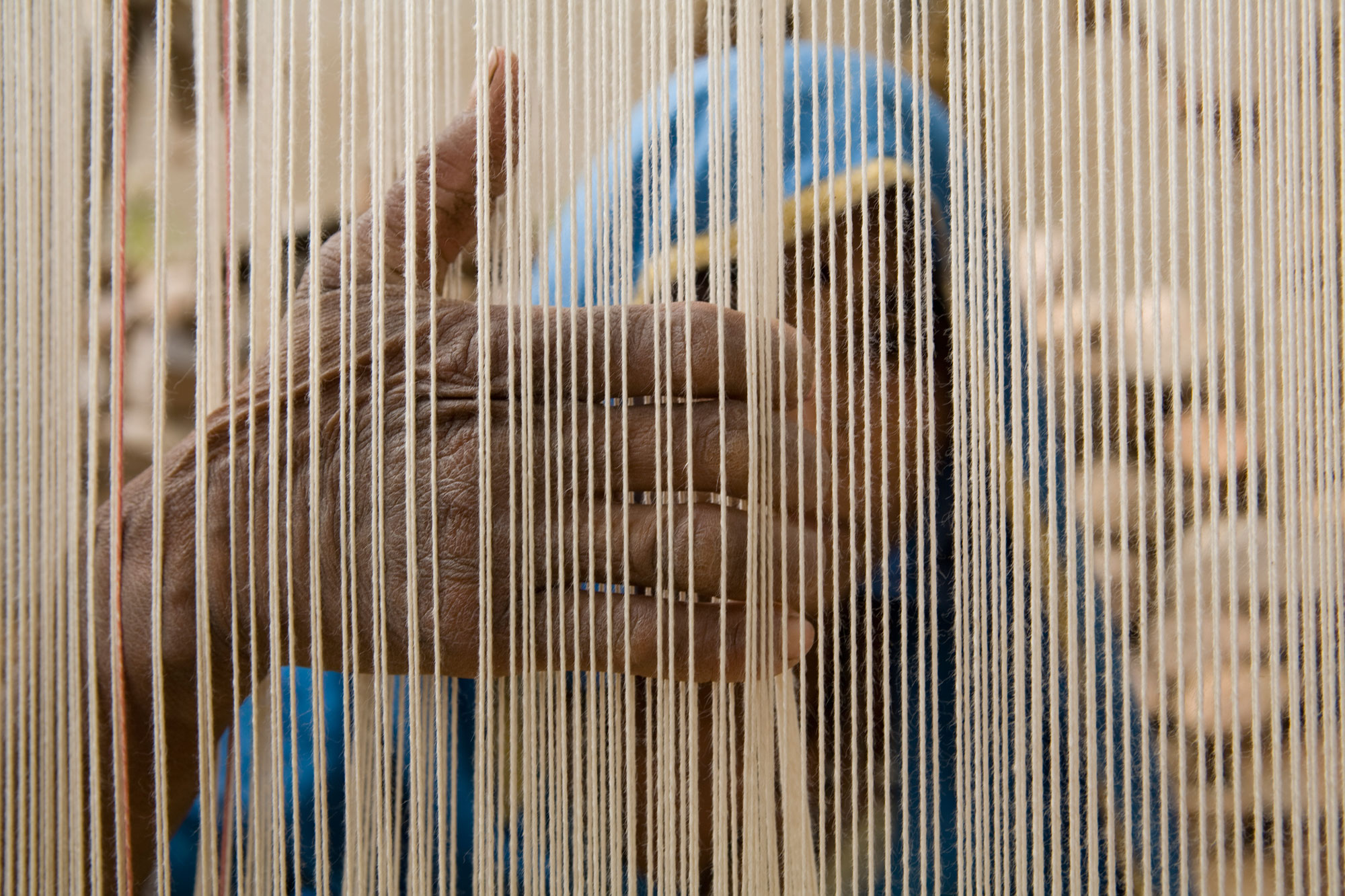 A woman weaving a rug in Jaipur 