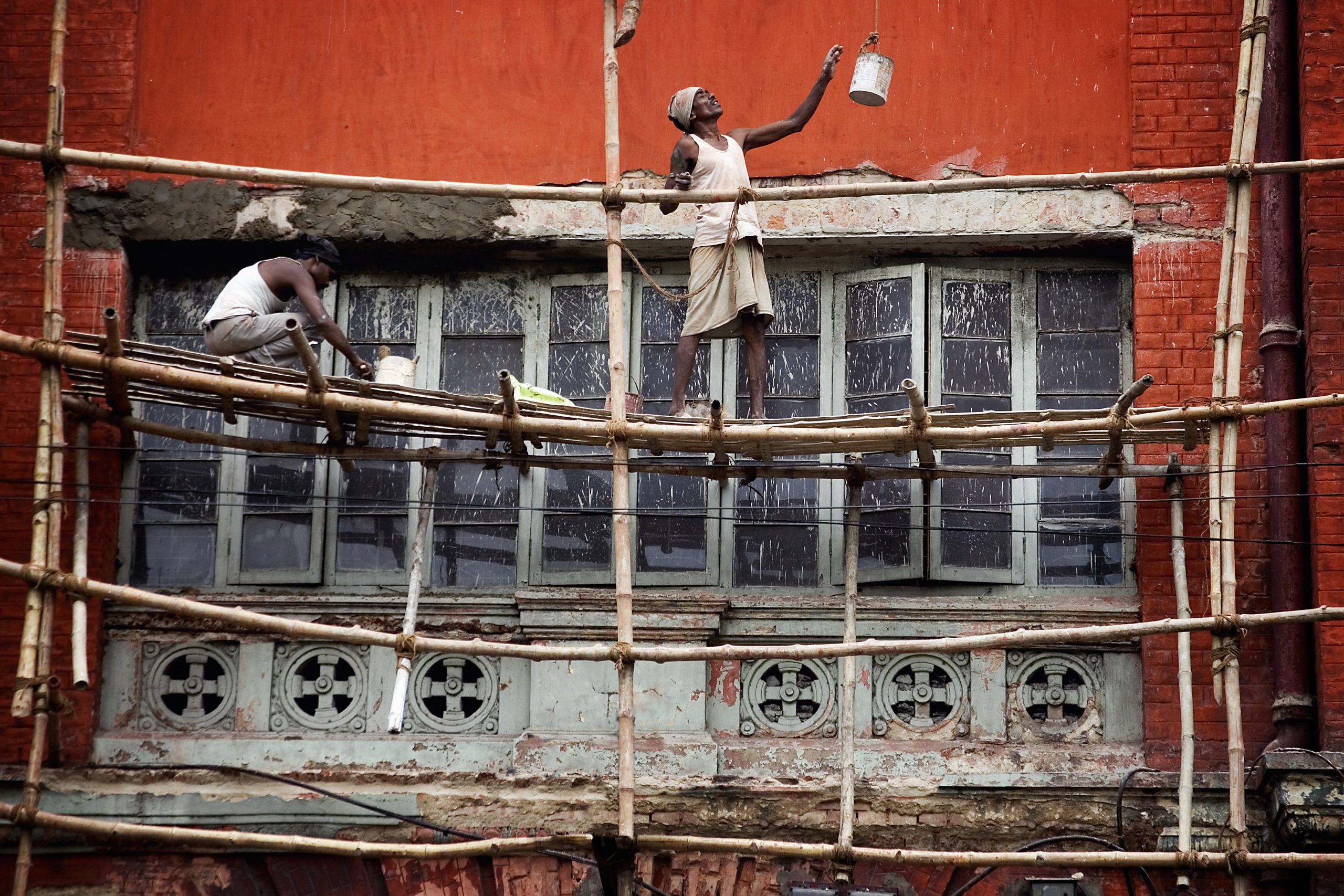 two men on bamboo scaffolding