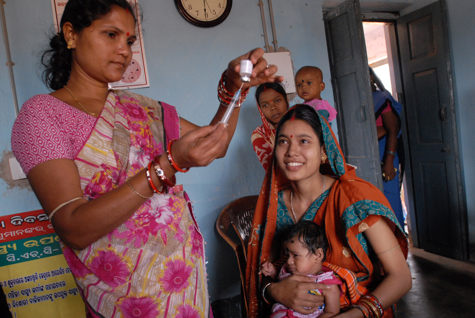 A women vaccinating a child