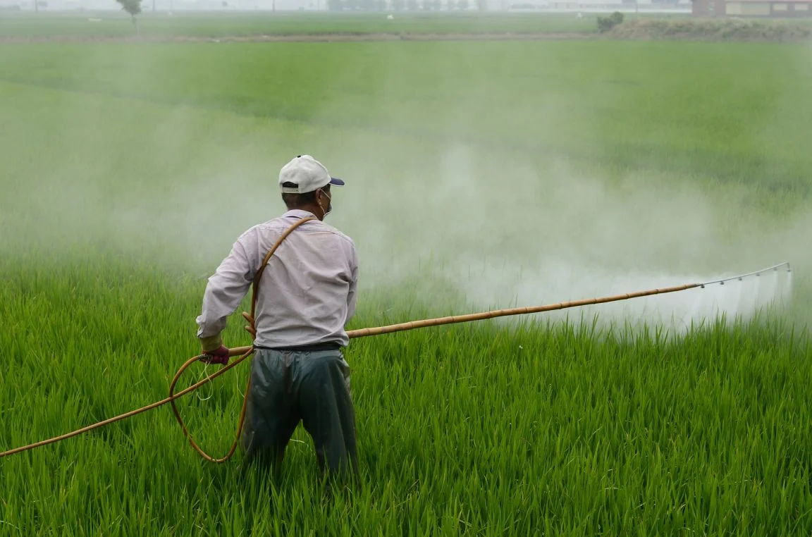 farmer spraying pesticide-health