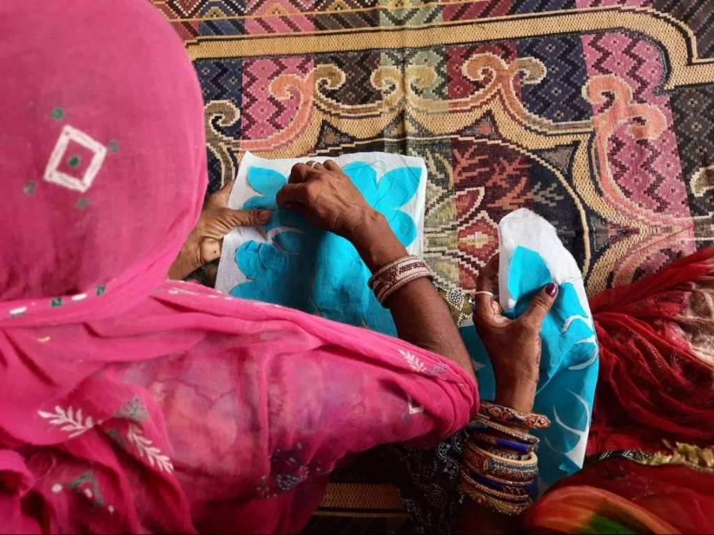 top view of two women artisans doing embroidery