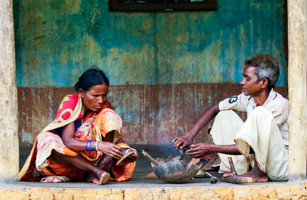 a man and woman dhorka artist sitting on the ground-ground up 