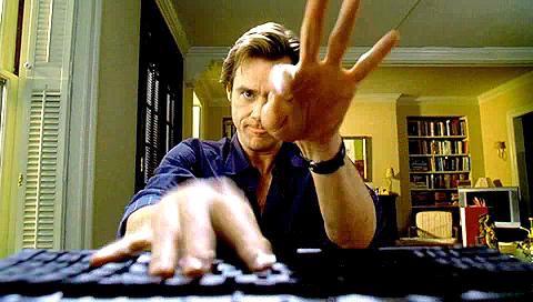 Jim Carrey typing on laptop in Bruce Almighty