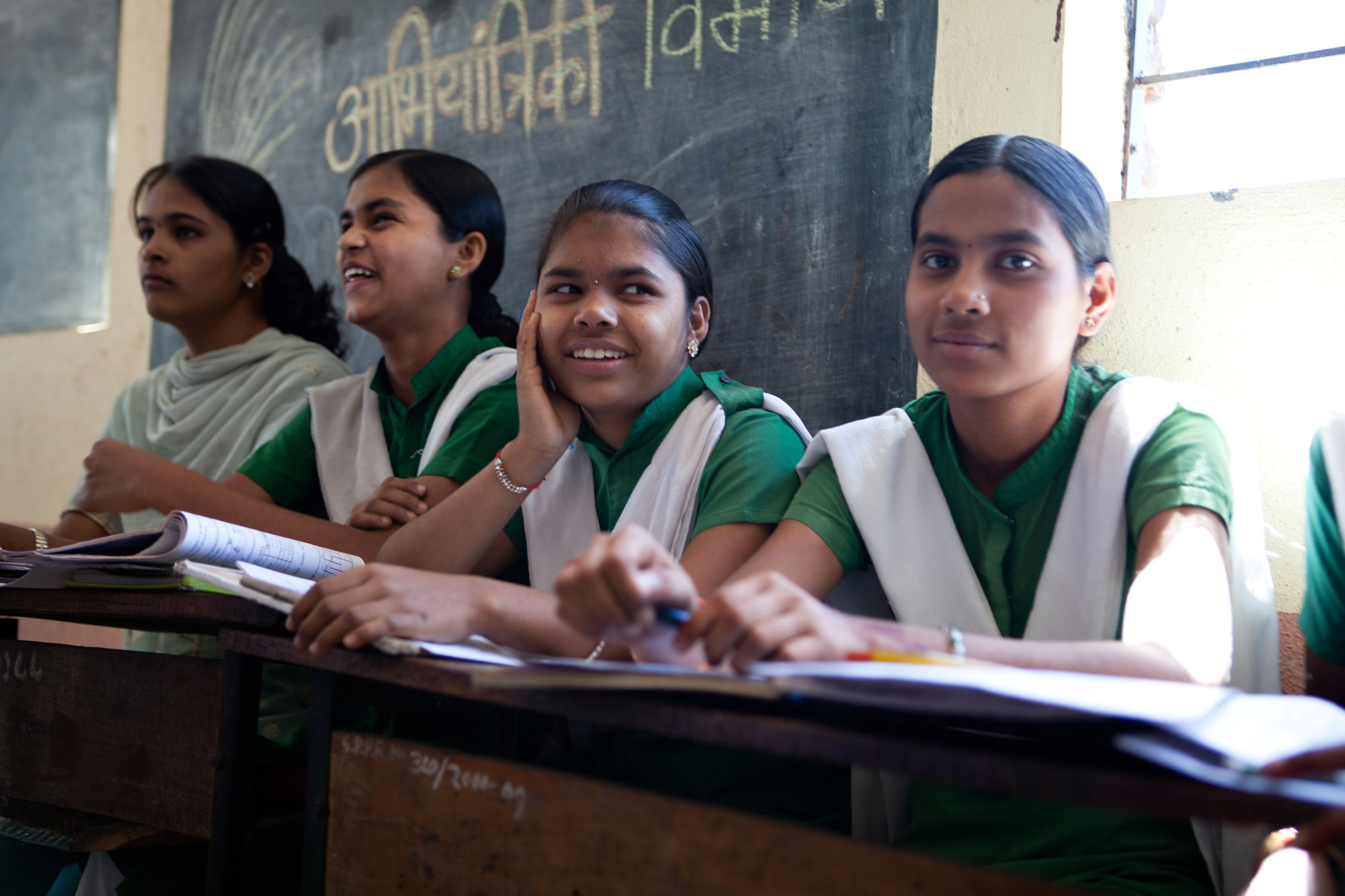 School girls in uniform sitting in a classroom