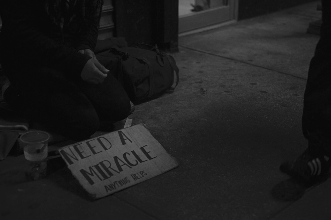 homeless person with a sign