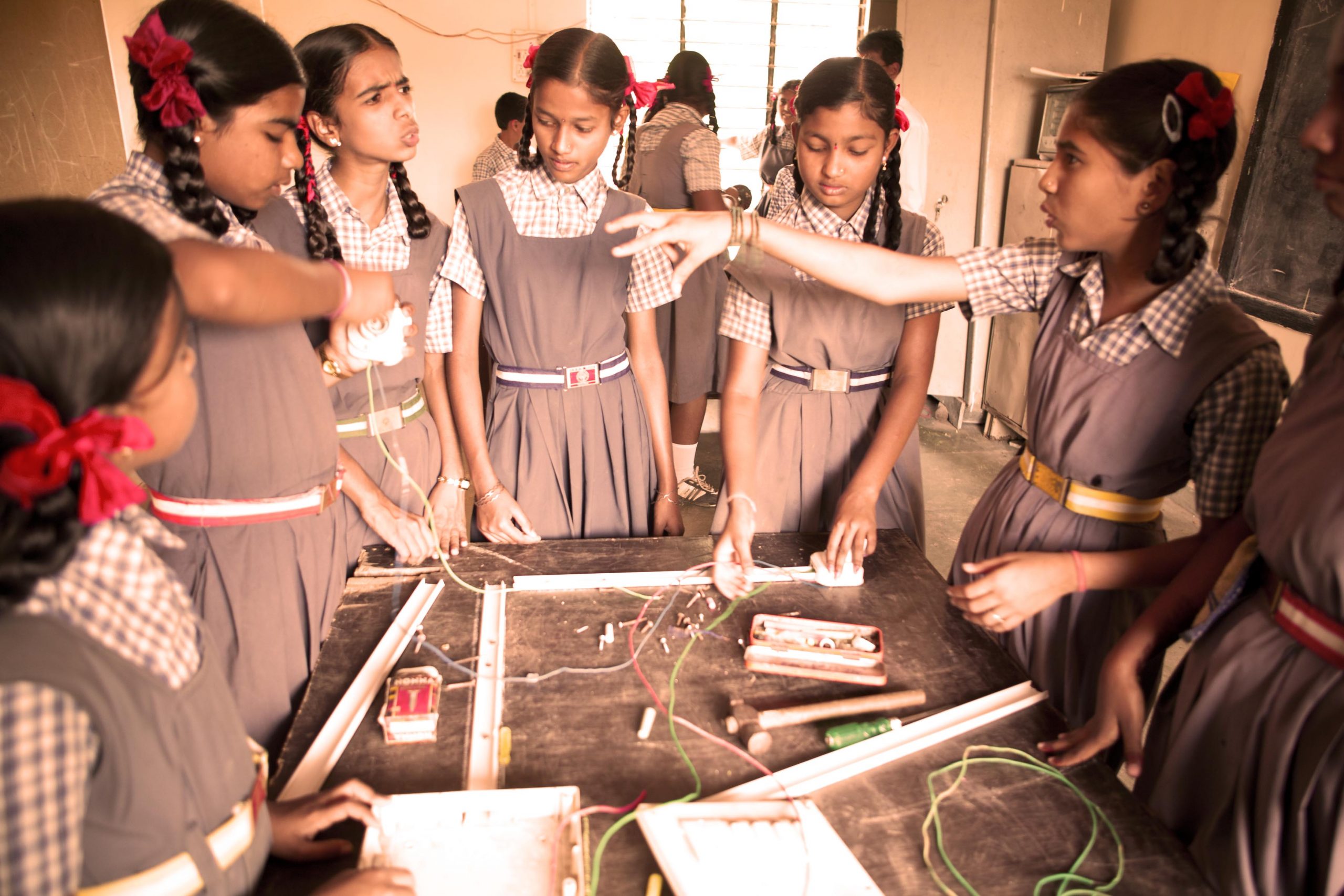 Indian schoolgirls in uniform working as a group 