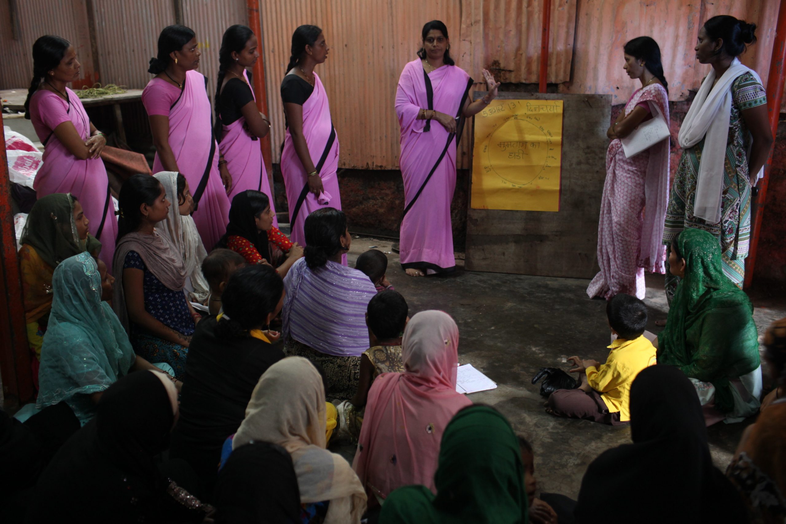 A few woman explaining something to the village women