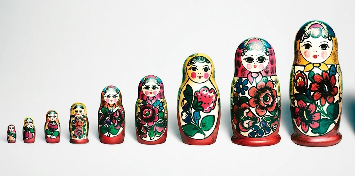 paperweights with designs of dolls on them placed in ascending order of height