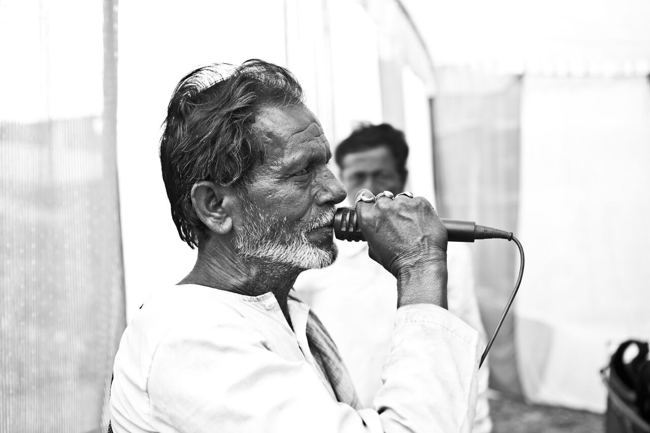 An old man speaking on the mic