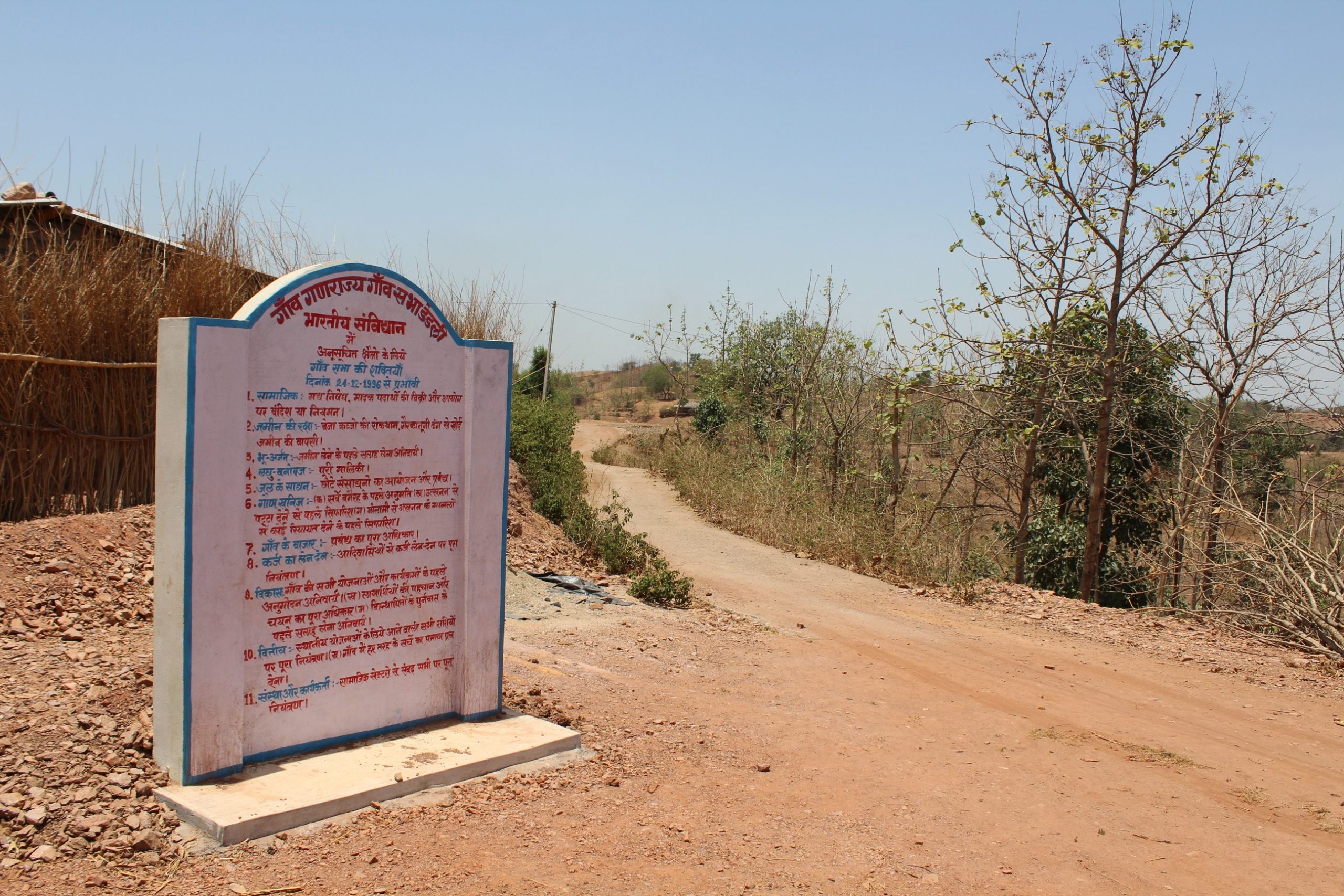 A structure with text in Hindi by a road -system of local self-government in India