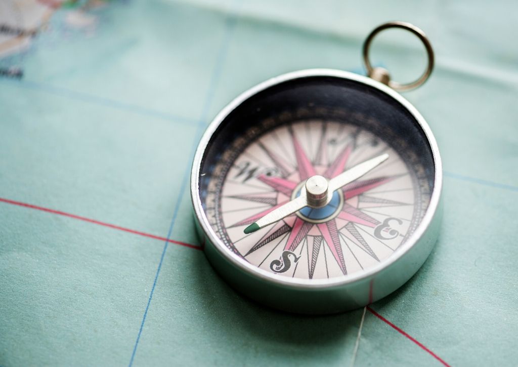 a compass lying on a table_social stock exchange_rawpixel