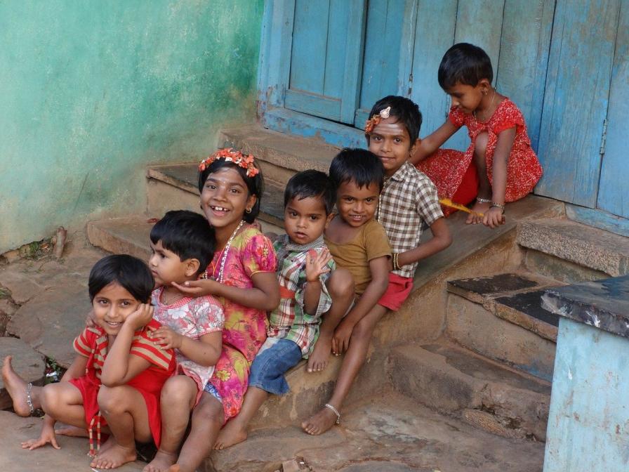 children sitting in a line on steps-children