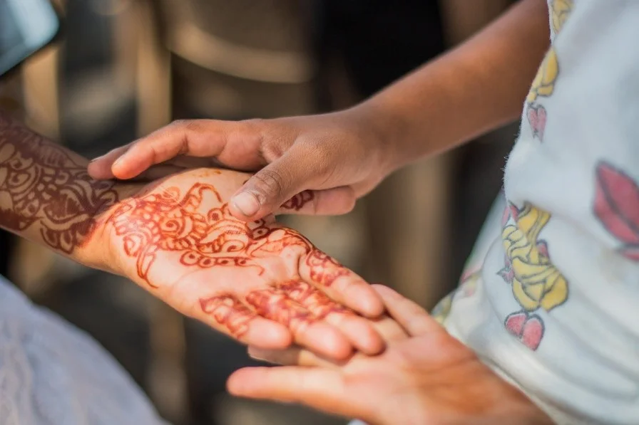 close up of two hands one with mehendi on it-child marriage