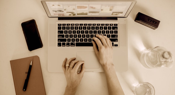 Laptop with a person doing some work