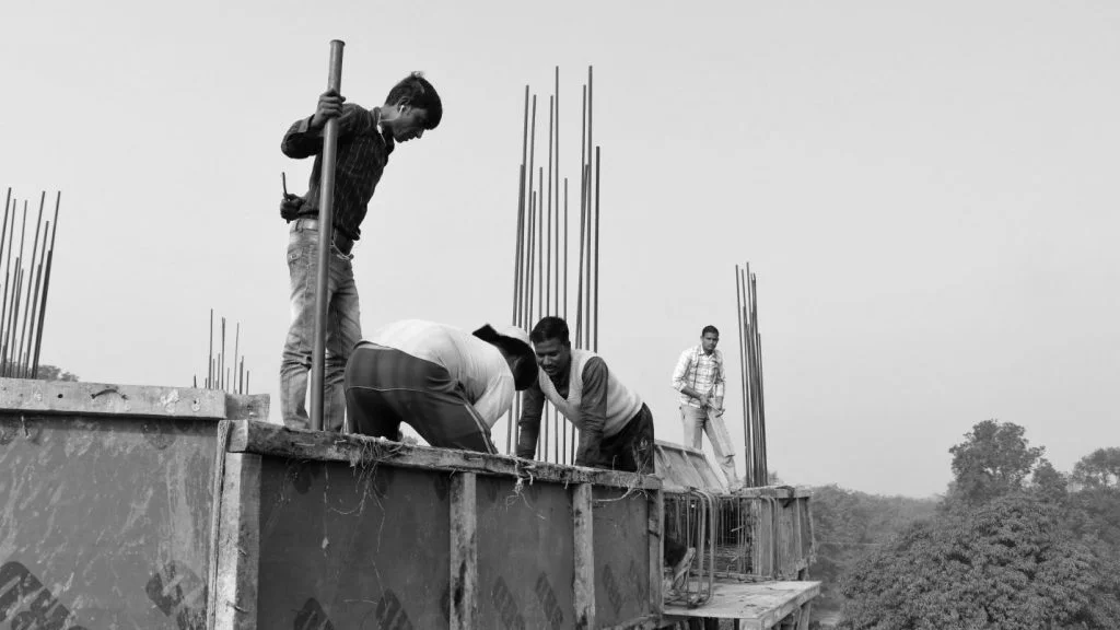 Migrant construction workers in Lucknow casting the roof of the building under construction on site