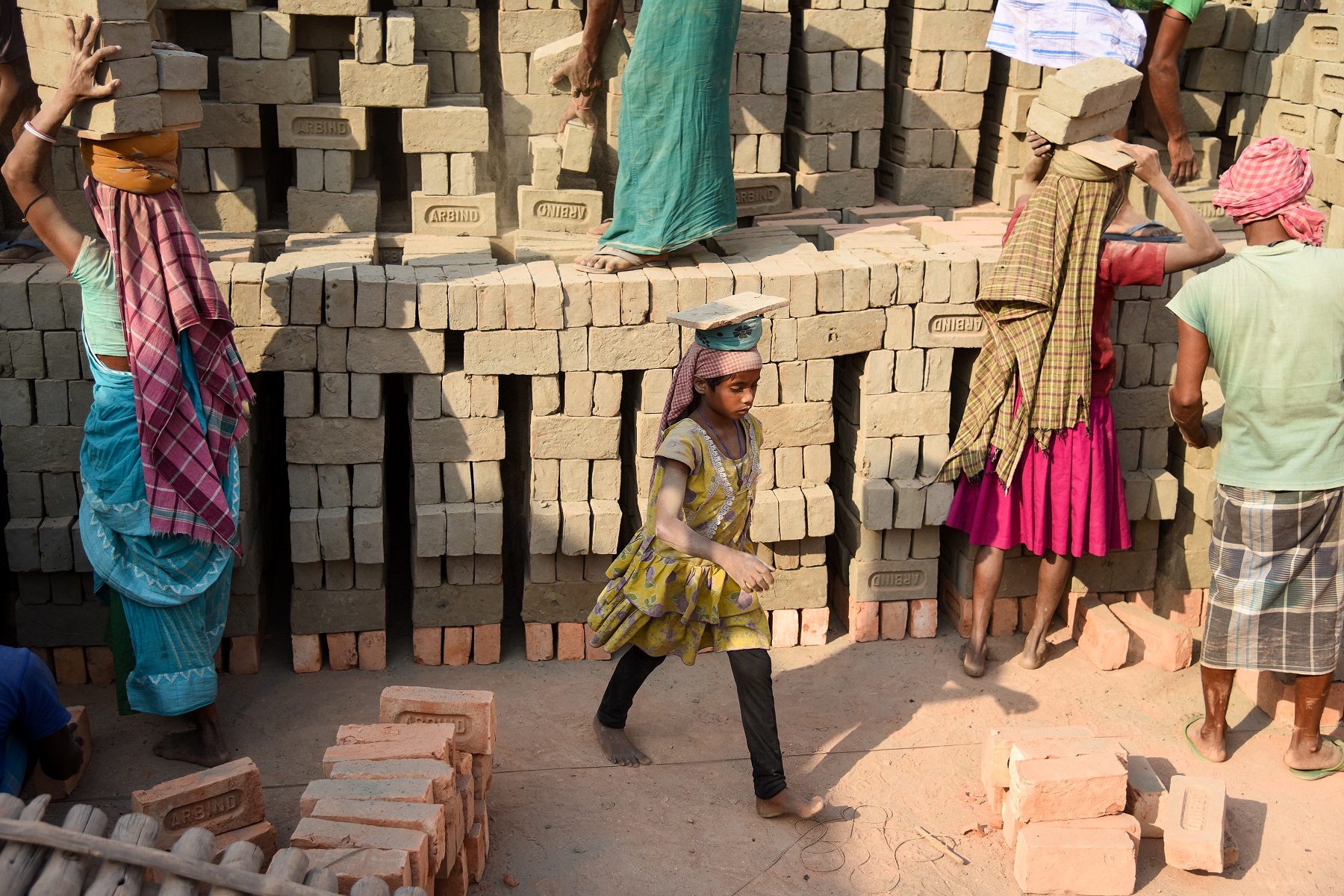 The entire family, comprising husband wife and children, move to the brick kilns and work as one unit for the full season of the operating kiln.