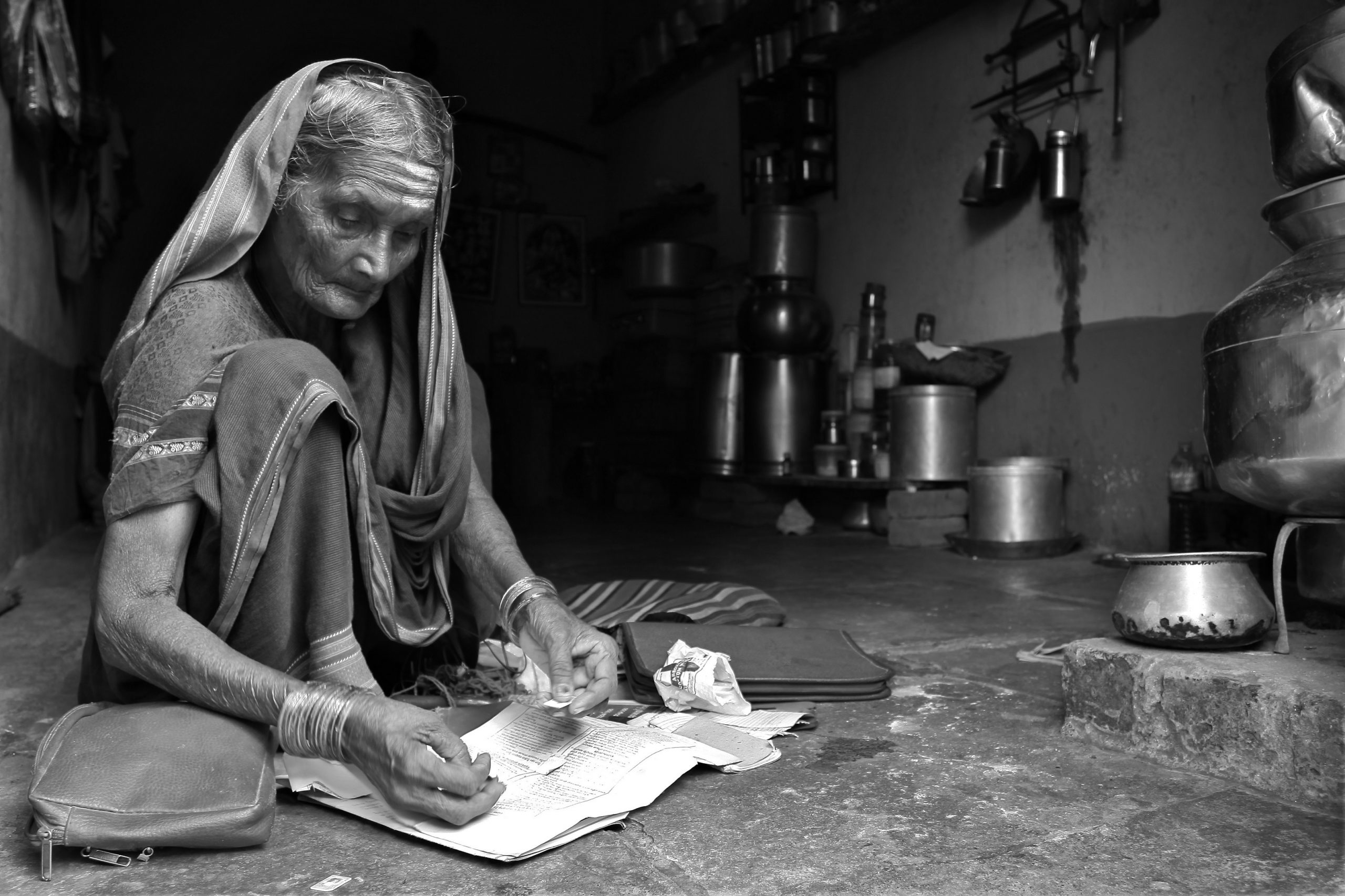An old woman in village India reading the newspaper