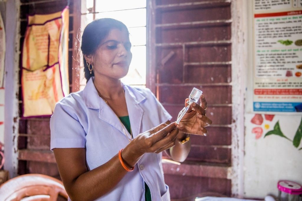 An ANM administering a vaccine