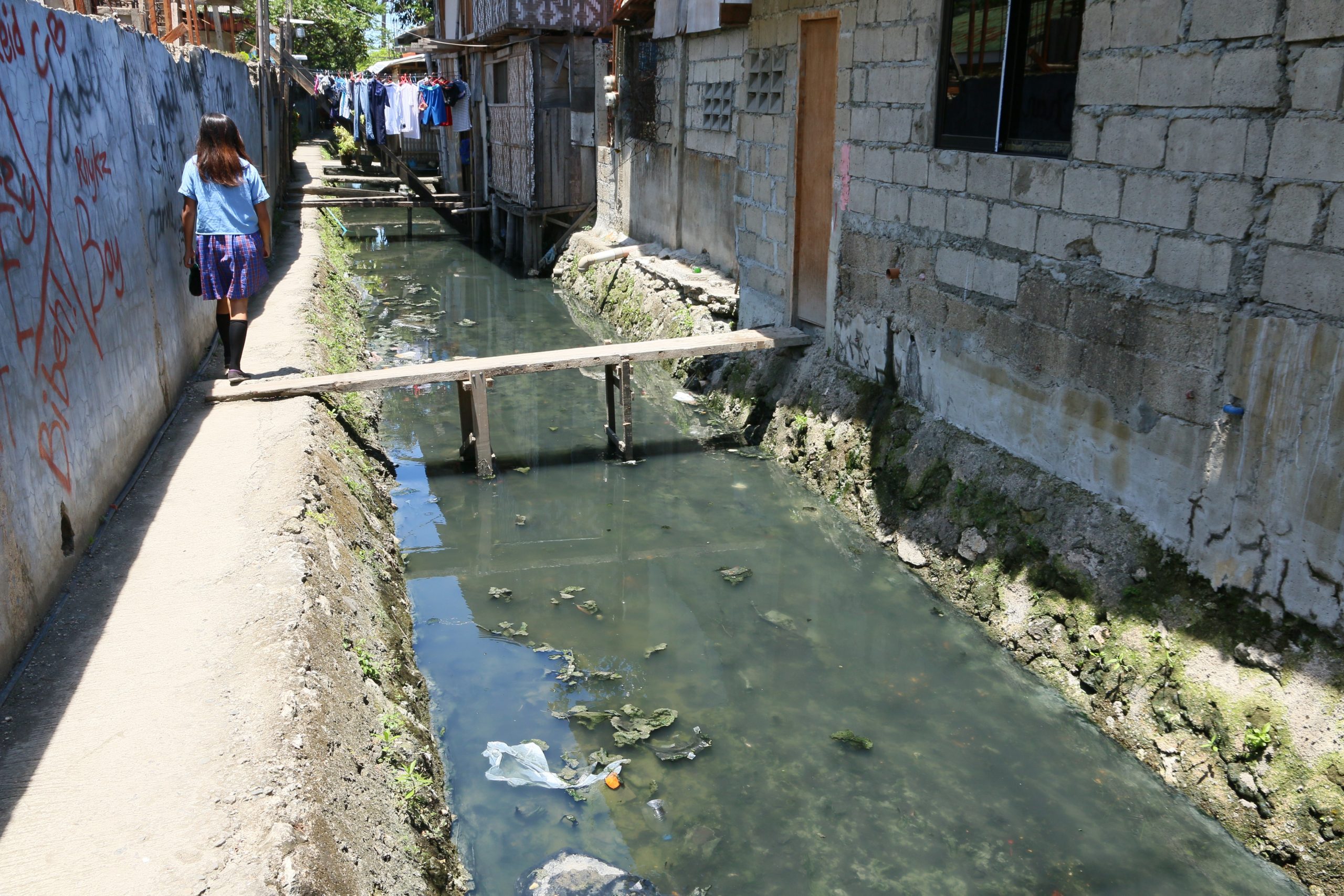 An open sewage water way next to houses_water pollution_Wikimedia Commons