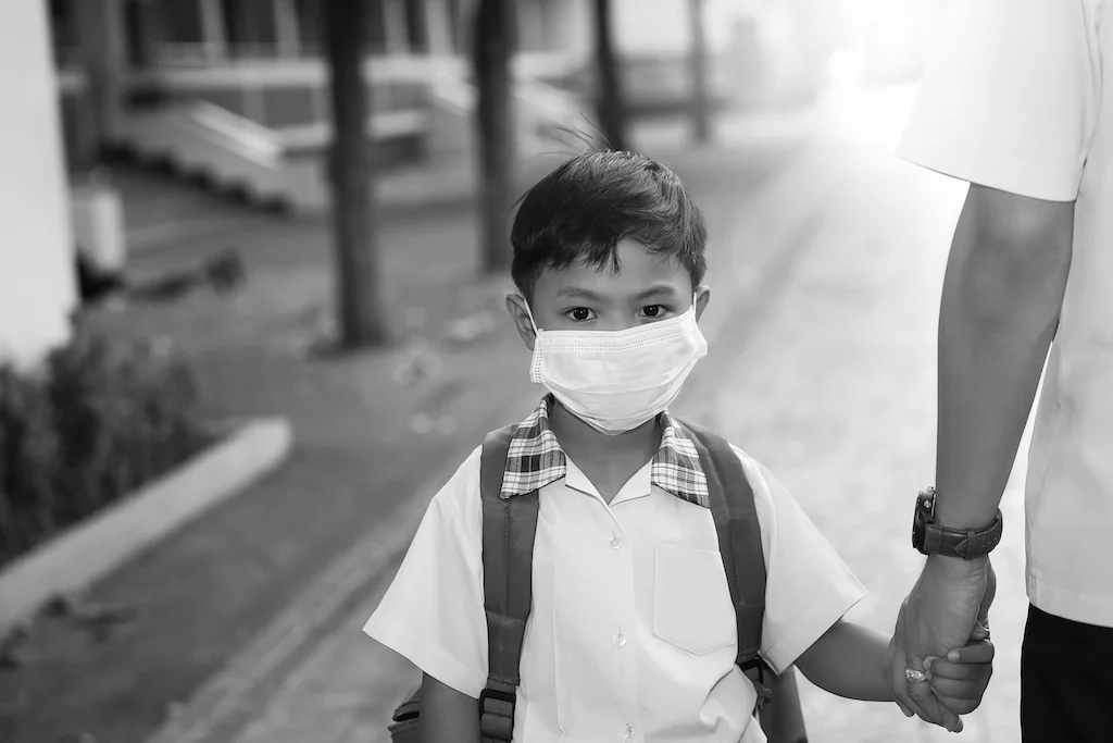 Boy in school uniform wearing face mask