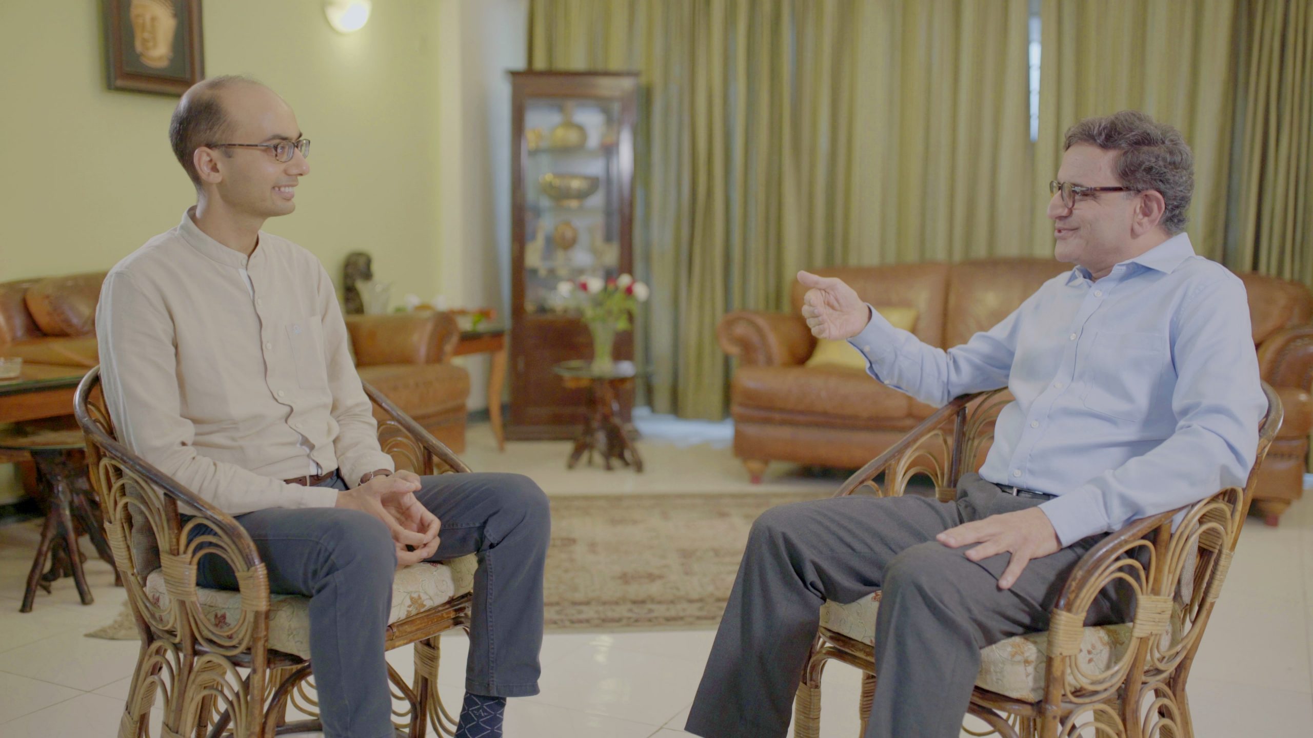 Pranav Kothari speaking with Dhir Jhingran, sitting on chairs. Indian education needs to be tolerant of its many languages