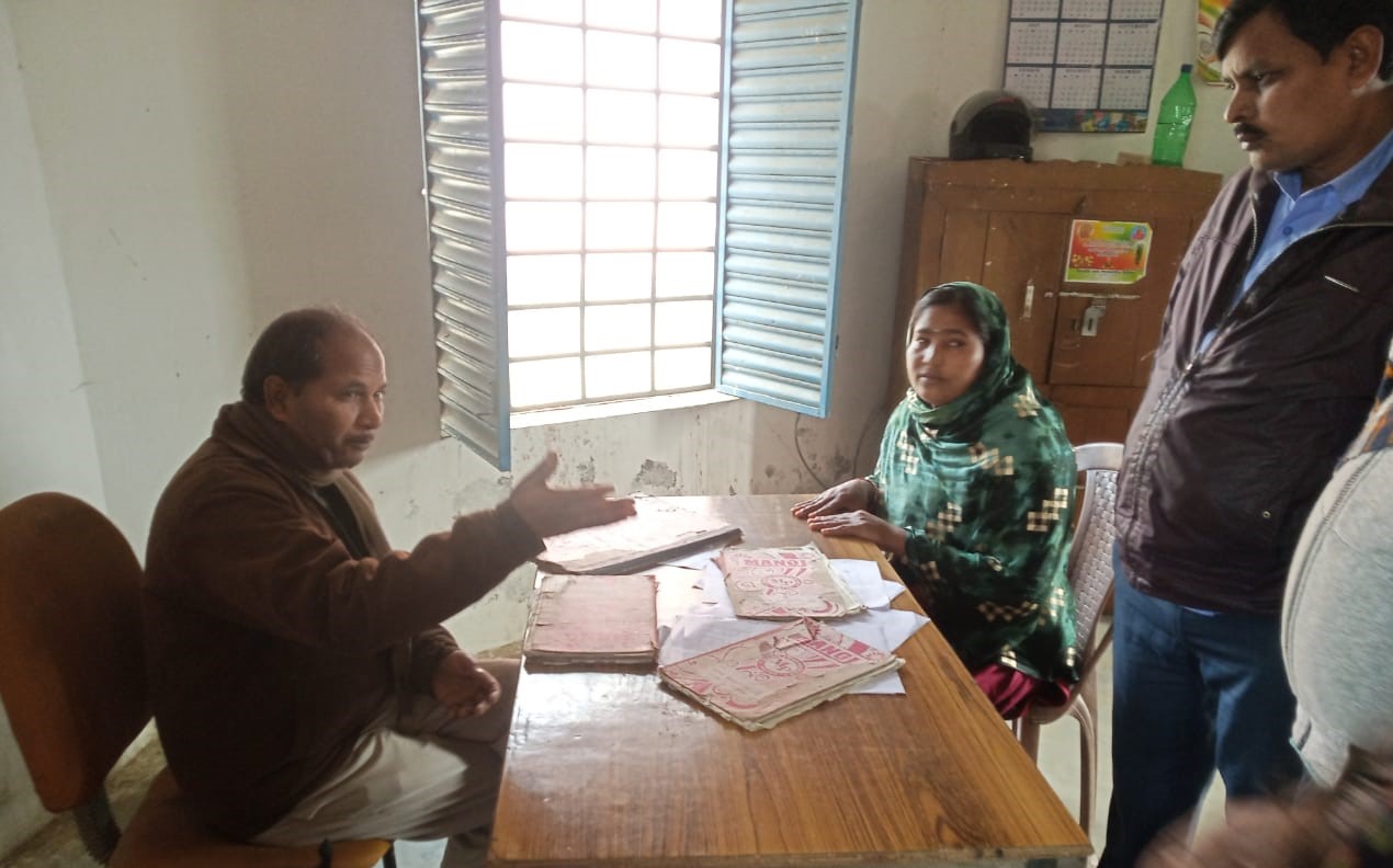 two people sitting in an office and talking-gram panchayat ward member