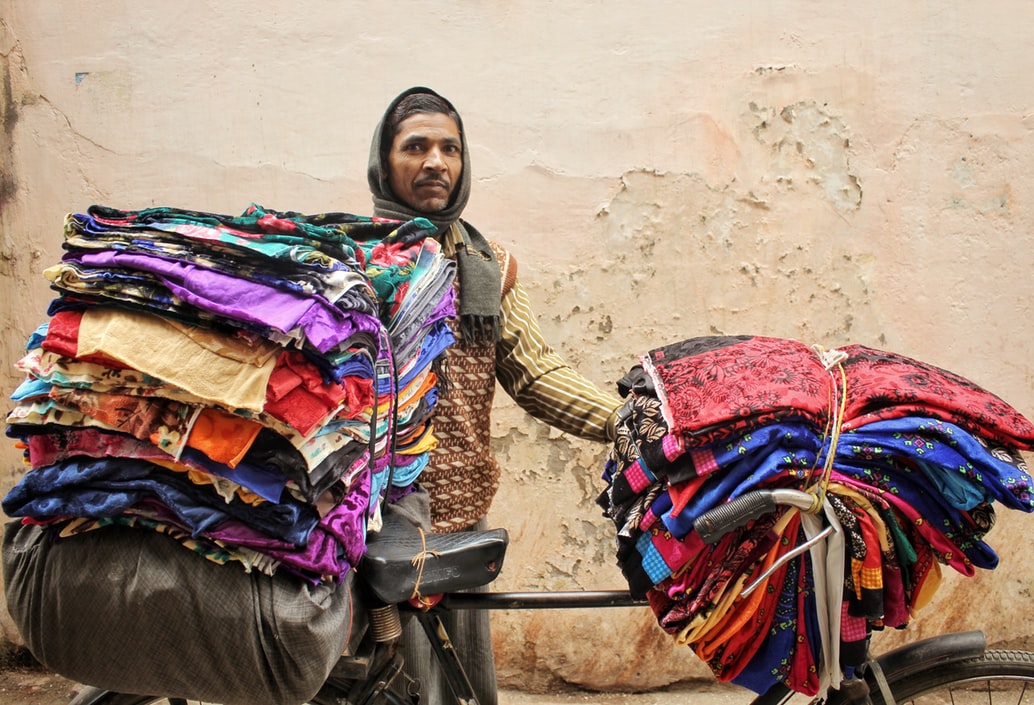 Man selling fabric on cycle