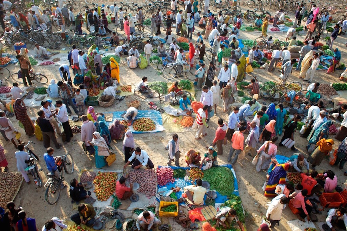 a crowded vegetable market in a village