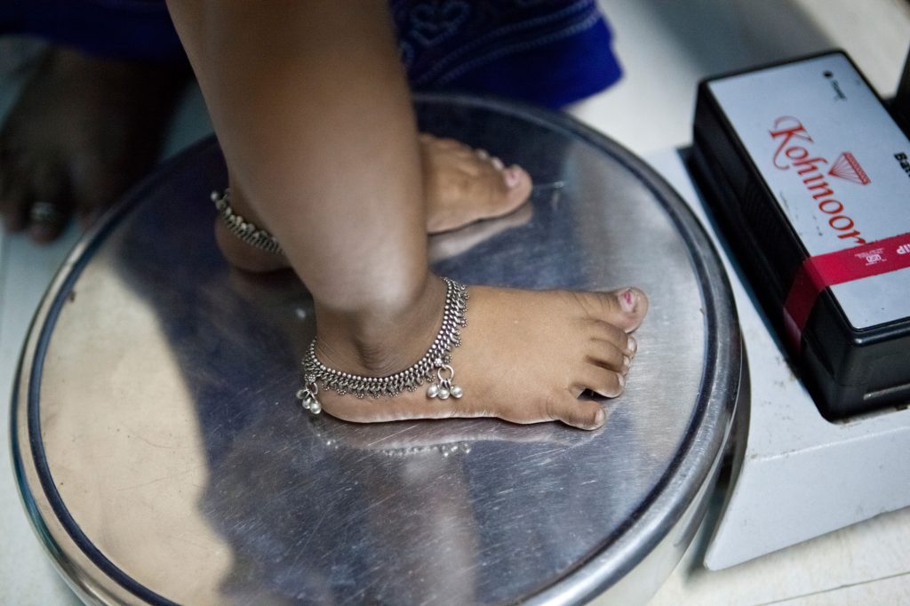child on weighing scale-tribal people-nutritional deficiency-Picture courtesy: Charlotte Anderson