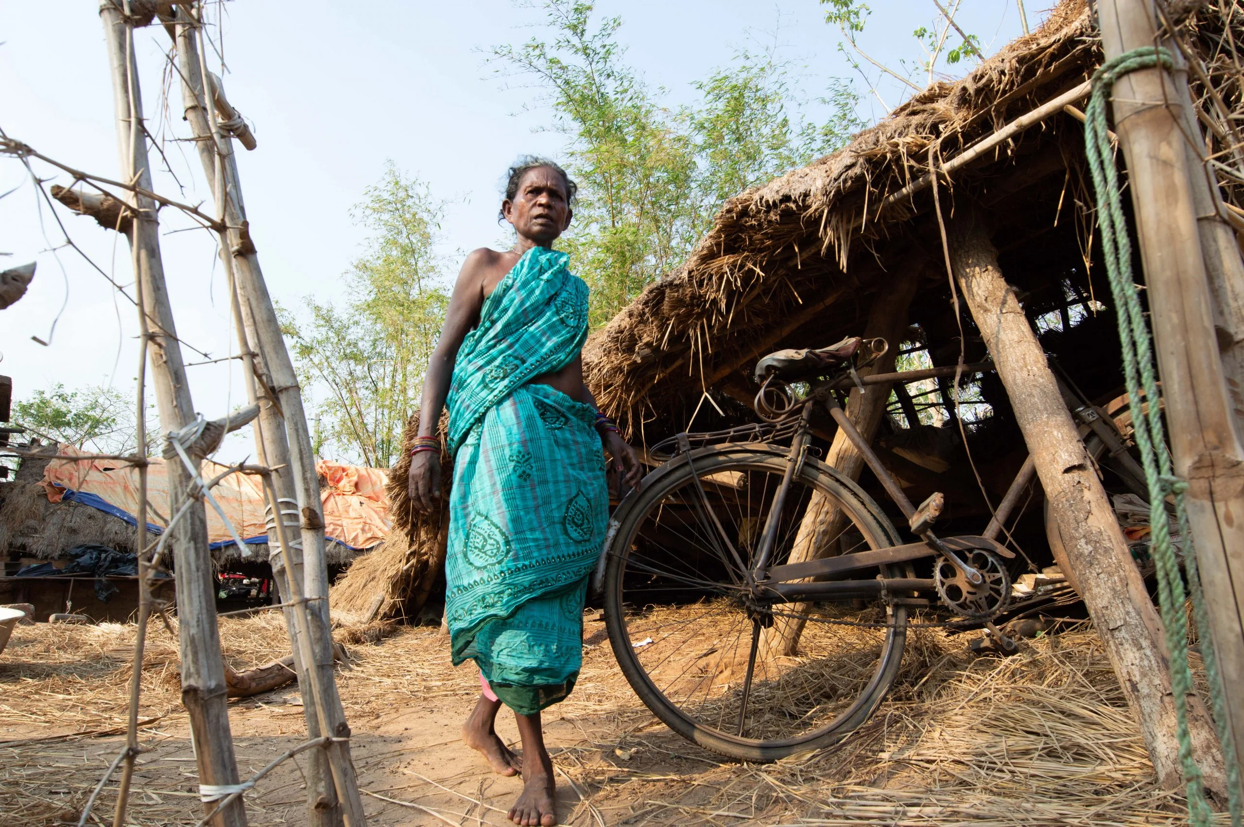 A woman walking through Sundarpur Mundasahi, Andharua, Odisha, after Cyclone Fani
