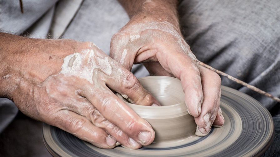 close up of hands of a potter crafting a pot-collaboration