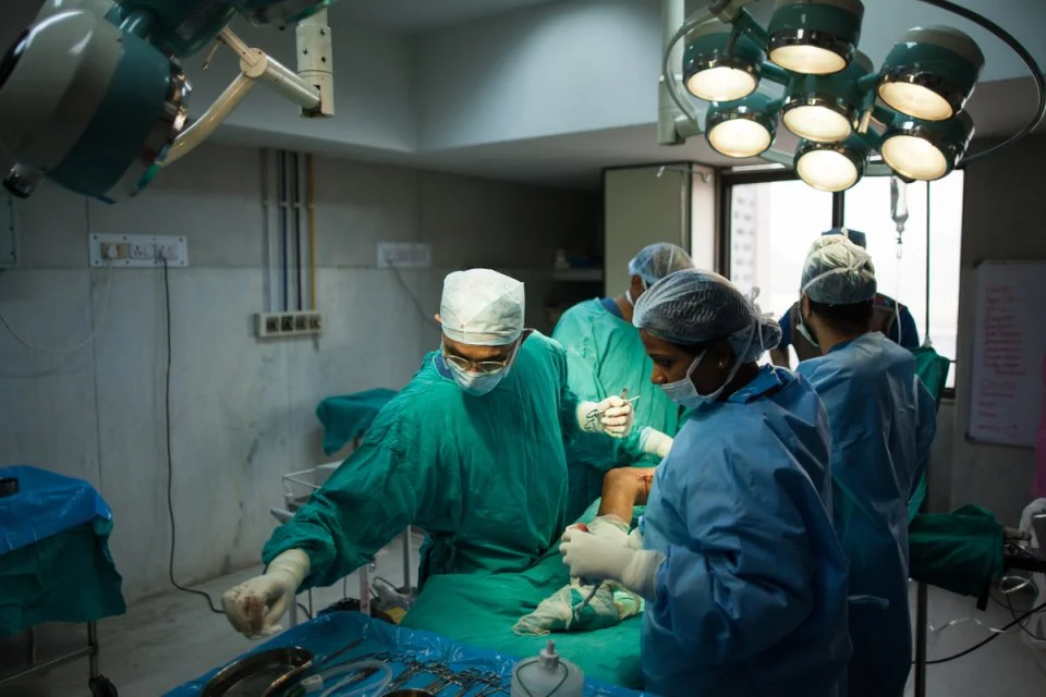 a team of surgeons performing surgery-health