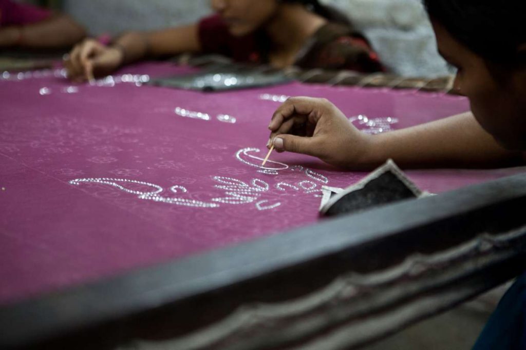 close up of a girl working on a piece of cloth-women entrepreneurship