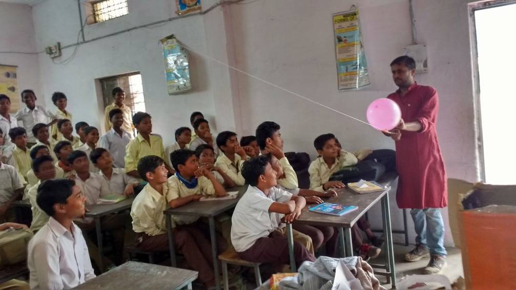 Navendu conducting a workshop in a class full of students