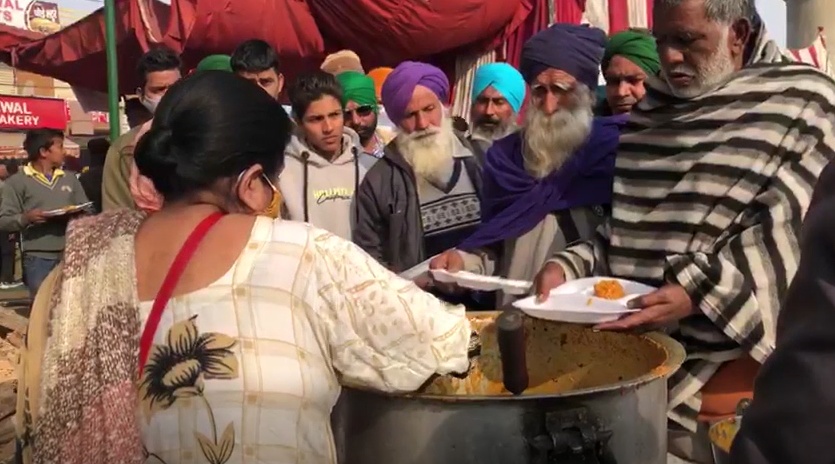 A volunteer serves meals at the farmers' protest at Tikri border