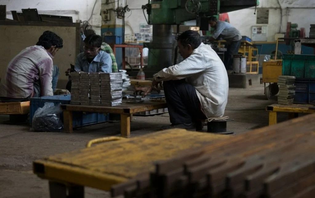 Three Indian factory workers at work