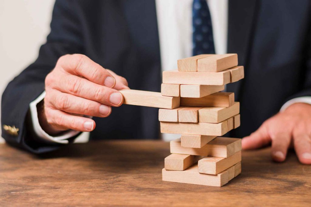 close up of a businessman playing jenga-philanthropy