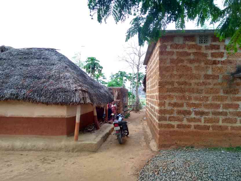 A bike parked in between two houses-rural housing