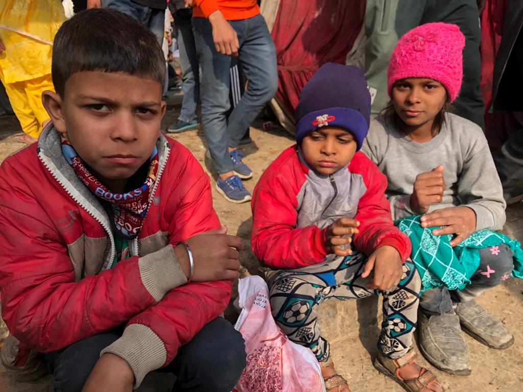 photo of three children sitting at the Tikri border farmers protest