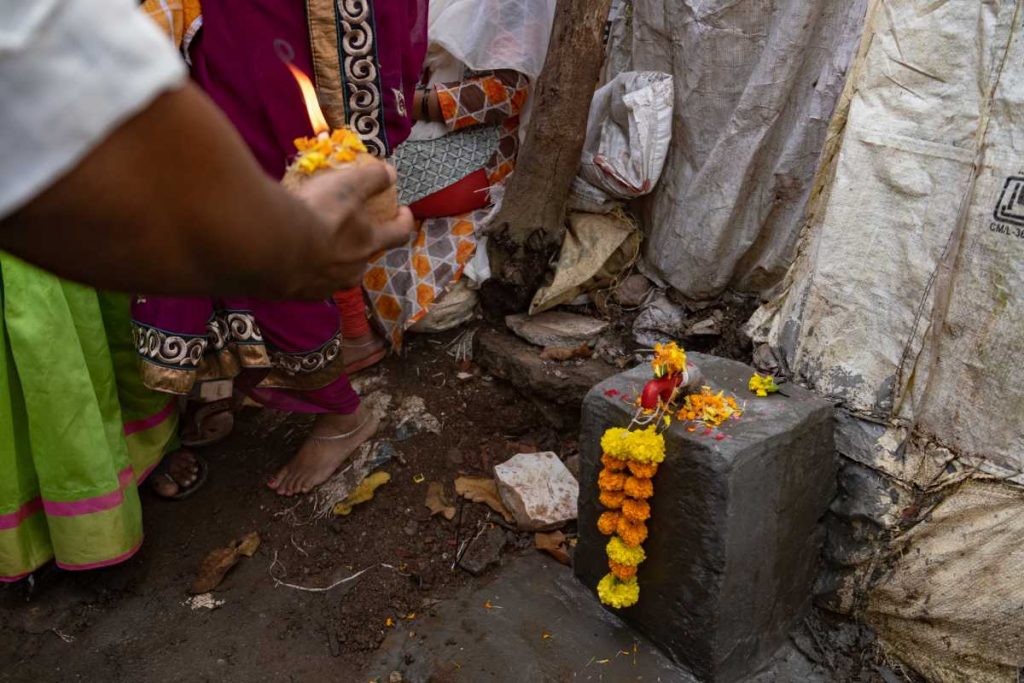 A tap on a cement block, garlanded and being worshipped-access to water