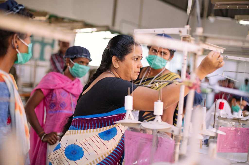 Female supervisor demonstrating scut work-garment factories