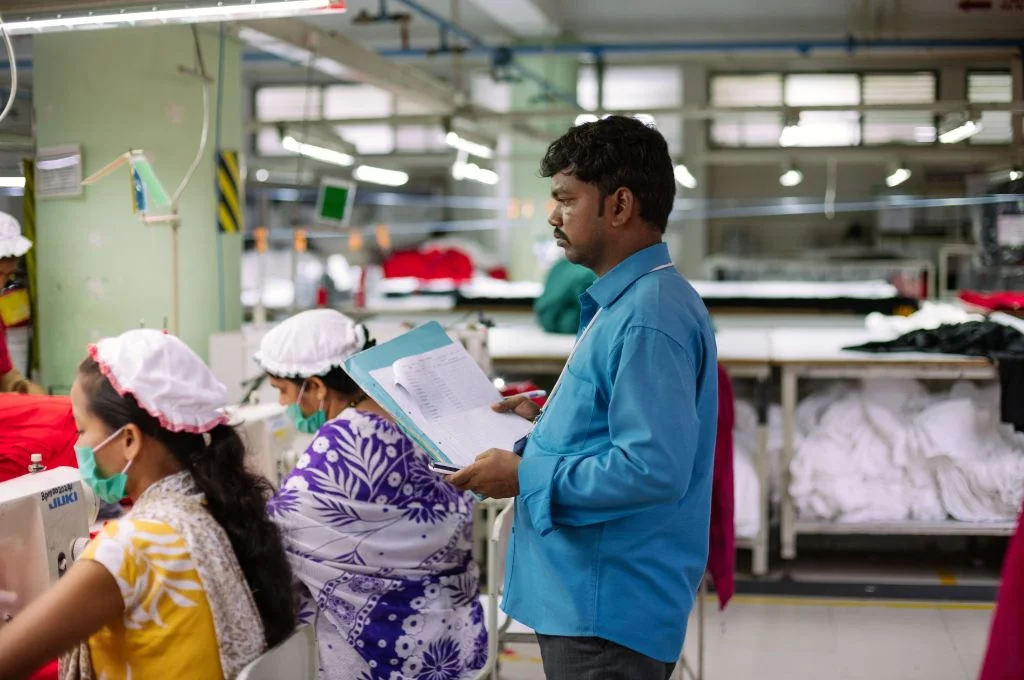 Male supervisor overseeing female garment workers-garment factories