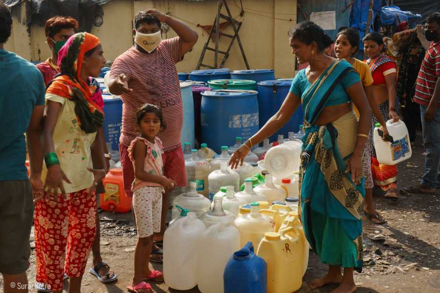 Image 10_People standing and talking next to stacked water containers-water for all-picture courtesy Suraj Katra