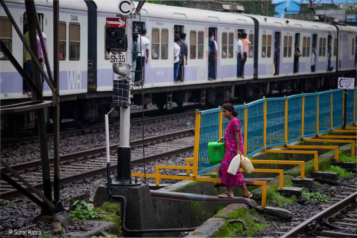 Image 4_ Woman at a train crossing at Dadar station holding cans_picture courtesy-Suraj Katra
