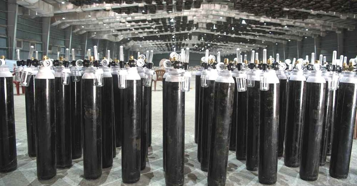 oxygen cylinders standing stacked in a warehouse